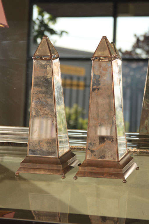 Distressed mirror and metal obelisk with hinged door at one side for insertion of votive candle