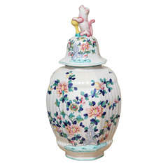 A Hand Painted Faience Covered Vase with Foo-Dog Finial