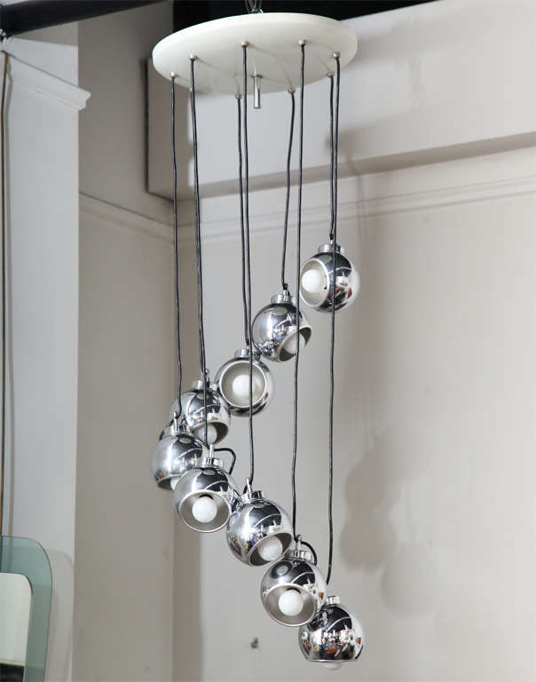 Exciting nine-light chandelier made in Milan 1960s by Lumi.
Each shade has a magnet so you can adjust the shade to several positions. You can also adjust the wire to any length.
Unusual model. 