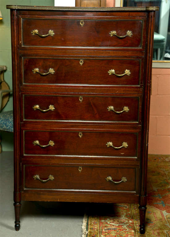 French Louis XVI style mahogany tall dresser, the bronze-banded top over a conforming case fitted with 5 banded drawers, raised on tapering fluted legs.