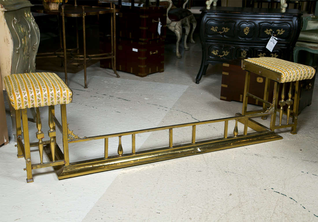 Charming solid brass fireplace bench, padded seat on each end upholstered in embroidery.