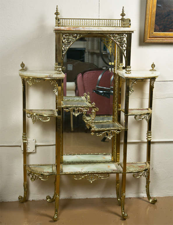 French brass and onyx dressing etagere, circa 1940s, the galleried top with finials over an oblong mirror, flanked by shelvings each side with onyx top.