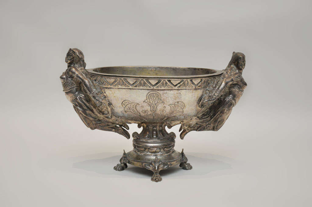 Rare Russian Nickeled Bronze Centerpiece. An extra-ordinary one-of-a-kind nickeled bronze etched oval centerpiece flanked on either side with full figured empress sculpture, waisted beneath supported on a circular plinth base resting on four paw