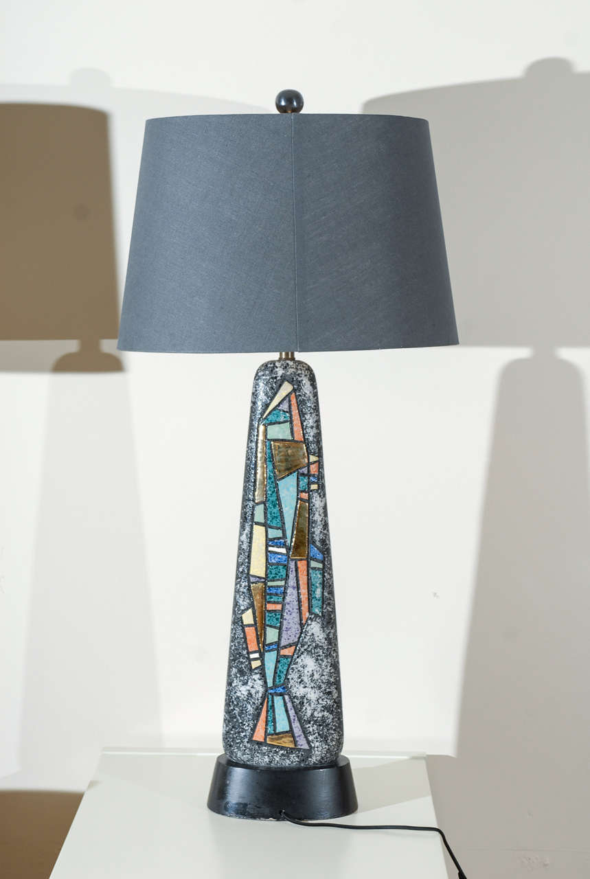 An unusual, beautiful pair of large scale ceramic lamps with a striking abstract inlay detail on both sides of the pieces. While the lamps are unmarked, they are reminiscent of Italian ceramic production of the 1960's. Excellent Vintage Condition,