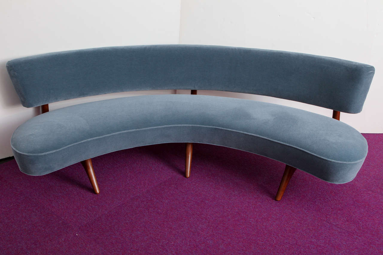 A sculptural walnut frame supporting a floating seat and backrest. Upholstered in pale blue mohair. A Kagan classic.