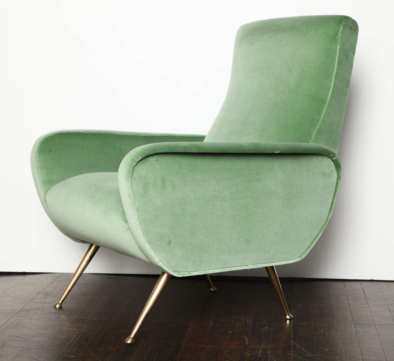 Elegant forms with sculptural armrests and great details. Polished brass legs with attached pod feet, and pale green velvet upholstery.