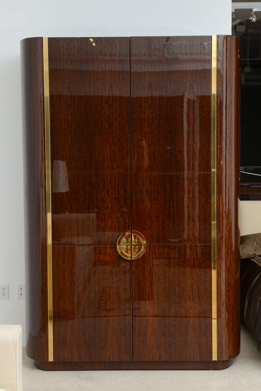 With four doors and rounded edges and brass inlay, the handles recessed, along with original receipts from Karl Springer Ltd.