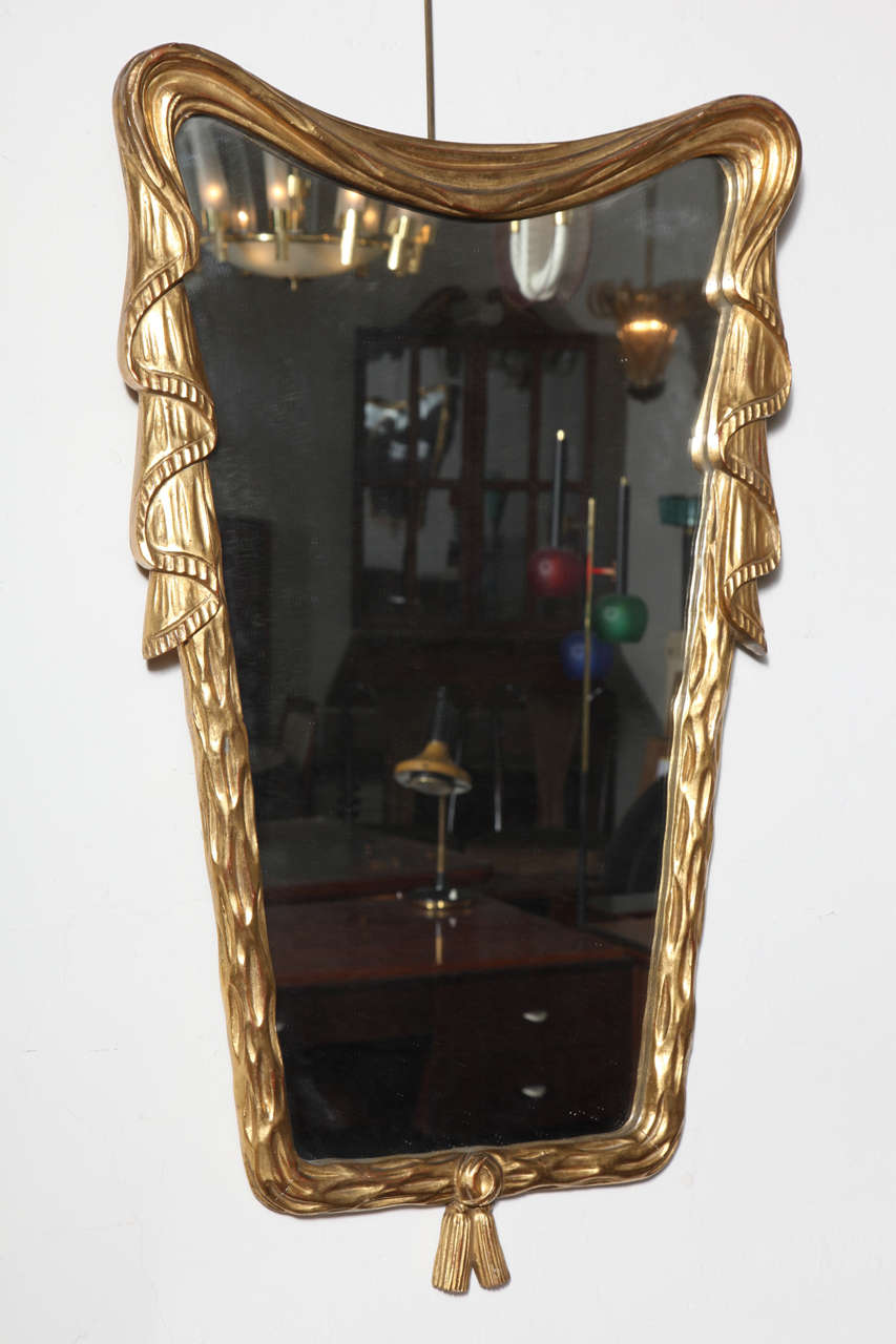 Stunning gold leaf mirror made in 1940 in Milan by Osvaldo Borsani.
Beautifully carved wood frame with drapery and tassel design.
Unusual. Great quality.
 