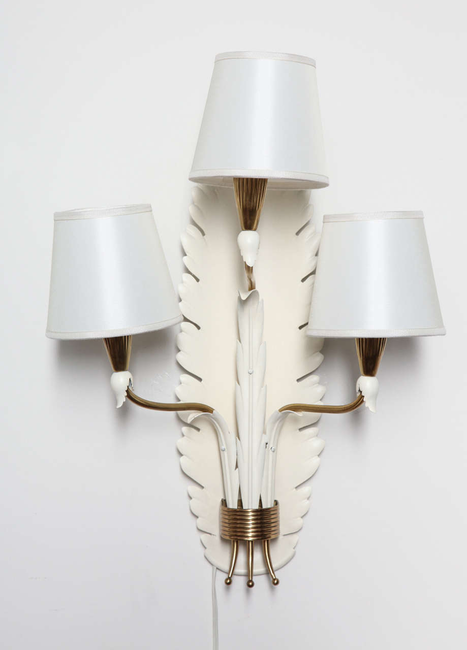 Elegant pair of sconces, made in 1940s by Arteluce and designed by Gino Sarfatti.
Hand made cream color lacquered sconce in a leaf shape with brass mounts and silk shades.
Unusual. Beautiful quality.
 