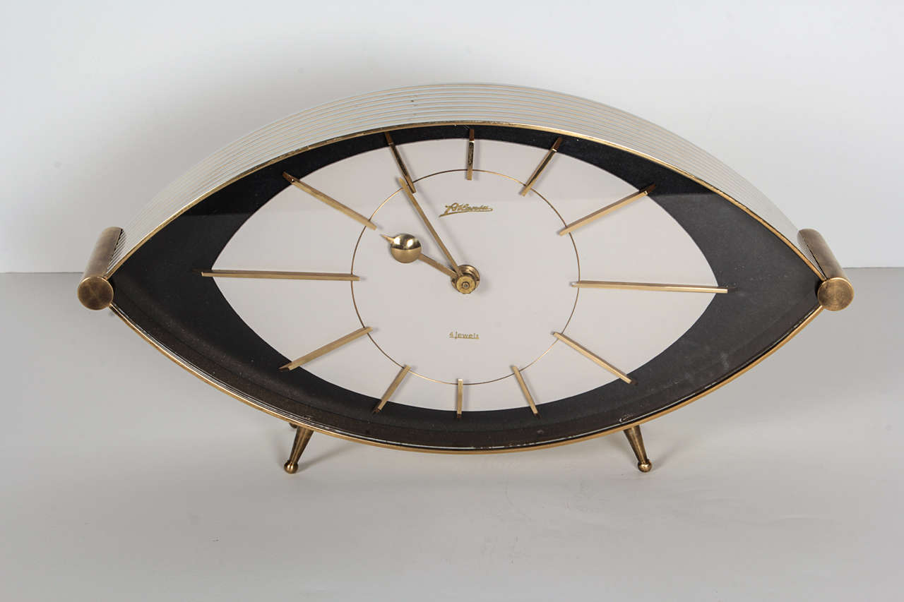 A stunning mid-century time piece with gorgeous brass & white enamel detailing. 8-day wind-up mechanism, no alarm. Needs to be wound every 3 days to ensure accurate timing. Otherwise, it is about 15 minutes behind after a week.