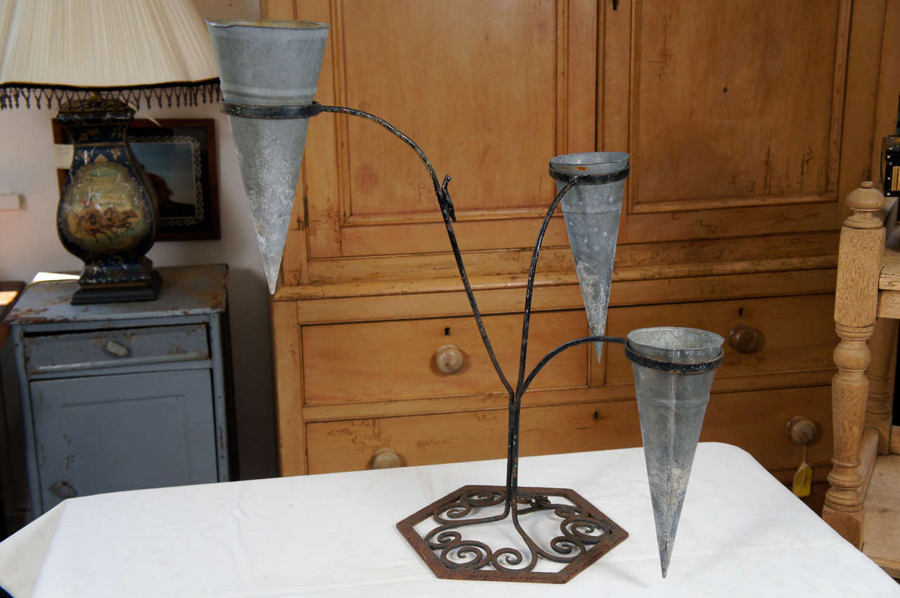 Wrought iron French metal florist's stand with 3 conical metal bouquet vases.
Metal cones can be removed.