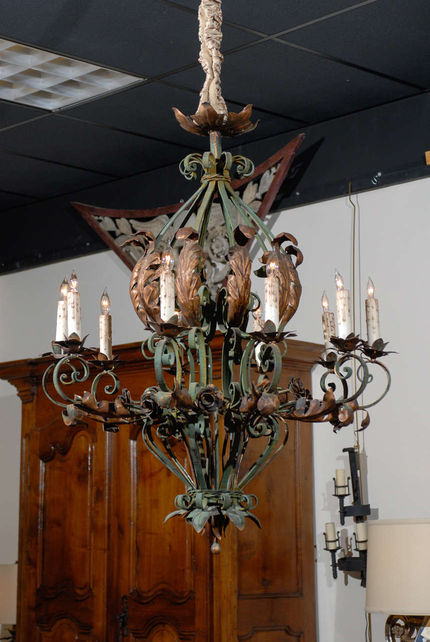 A Rococo style green painted iron chandelier with 10 lights and gilt tole acanthus leaf & rose detail. 

William Word Fine Antiques: Atlanta's source for antique interiors since 1956.