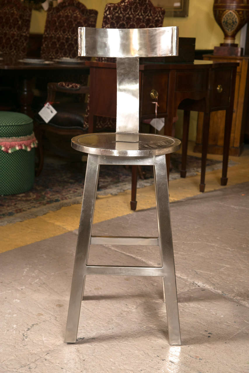 A set of three deco styled 26 inch bar stools. Each with a circular set having a cutout for handling. The top steel T-shaped curved back for comfort. Very sturdy and strong. Price is for one stool only. Can buy as many as you like.