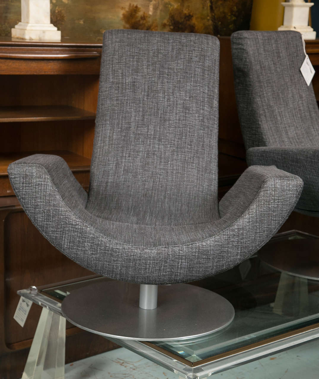 Pair Italian Arketipo Fly Chairs by Mansoni and Tapinassi. High-backed armchair with swivel base and a slender line which offers an elevated degree of comfort, ideal for relaxation. The frame padding is made of cold expanded polyurethane and it has