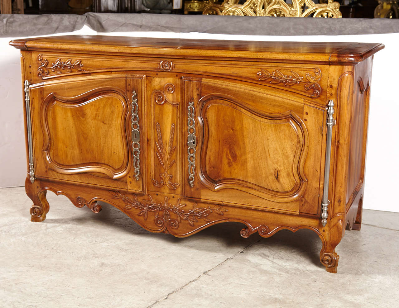 This rare large buffet from Arles is from the early 1700s. It has been hand carved and pegged throughout. The impressive large door hinges and hardware are original to the piece, and it has been made from French Blond Walnut Wood.The piece has