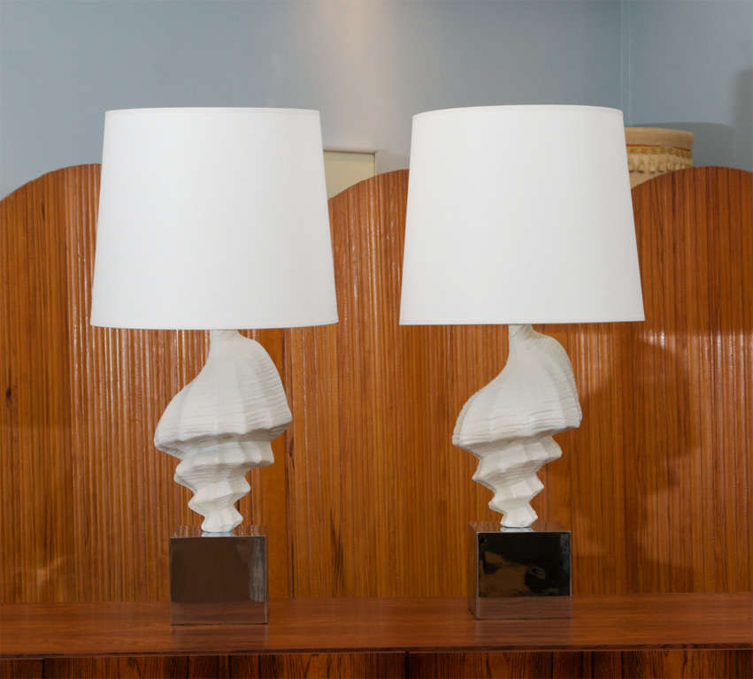 Pair of shell form table lamps, composition sea shells on chrome bases. Shades not included.