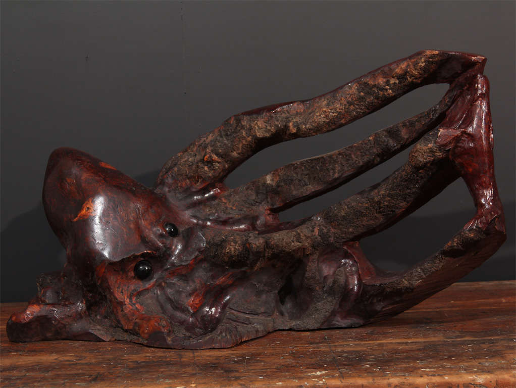 I just can't resist burled sculptural pieces which were prevalent from the 50's through the 70's.  This unsigned octopus is nothing short of brilliant.  The texture of the bark mimics suckers on the tentacles and the resin eyes are so wrong they're