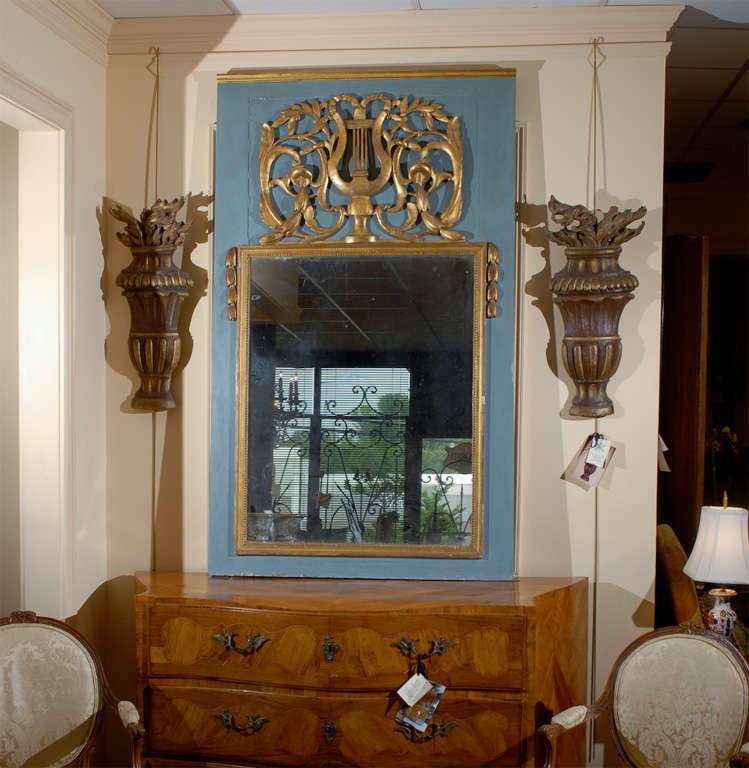 A Louis XVI style blue painted and parcel gilt trumeau mirror with lyre detail. 

William Word Fine Antiques: Atlanta's source for antique interiors since 1956.