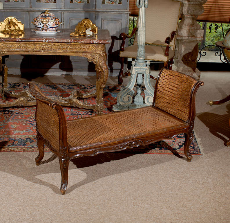 A late 18th century French Louis XV Style Walnut Bench with cane and arms. 

For many more fine antiques, please visit our online gallery at: www.williamwordantiques.com

William Word Fine Anitques: Atlanta's source for antique interiors since