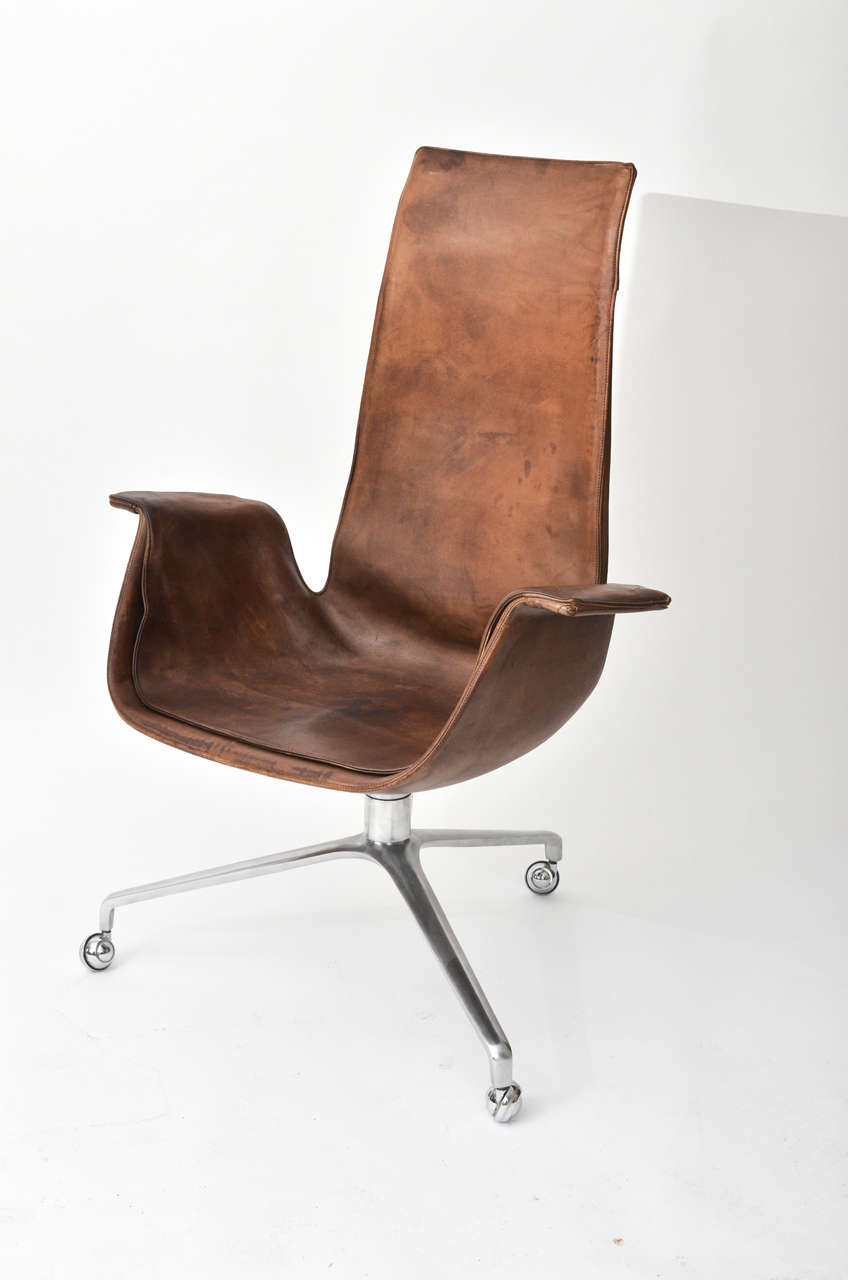 Vintage High Back Tulip Desk Chair in Aged Brown leather with  on casters.