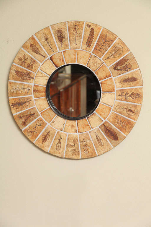 Rare and unique mirror by the famous French ceramist, ROGER CAPRON.  This is from his 'leaf' collection. Each leaf impression is different and taken from the real plant.  Done in the city of ceramics and tile and Picasso, Vallauris, France.