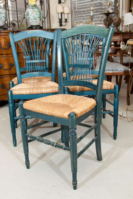 SET  OF FOUR  PAINTED BLUE RUSH SEAT SIDE CHAIRS- FINISH IS WORN TO GIVE OLD LOOK. THERE IS A 5TH CHAIR THAT IS MISSING A BACK CENTER BACK SLAT WITH IS INCLUDED AT NO COST.RUSH IS HAND MADE..SEAT  HEIGHT 18