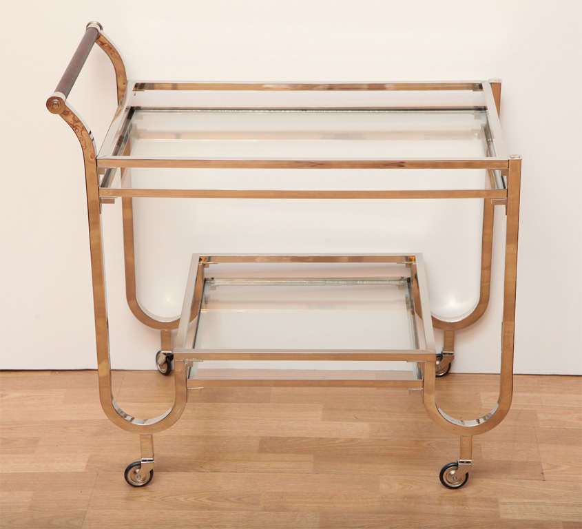 Modernist rolling drinks cart with leather wrapped handle.