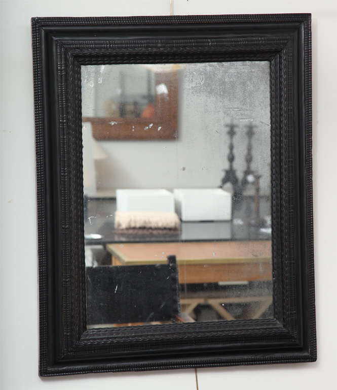 17th Century ebonized mirror plate within a carved frame and waved borders

Stock Number: LM0011