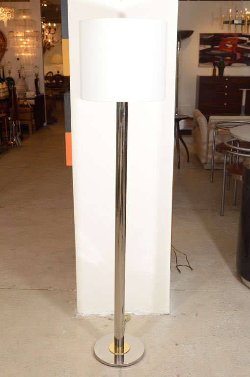 Exceptional chrome floor lamp with a subtle brass accent at base by Nessen.