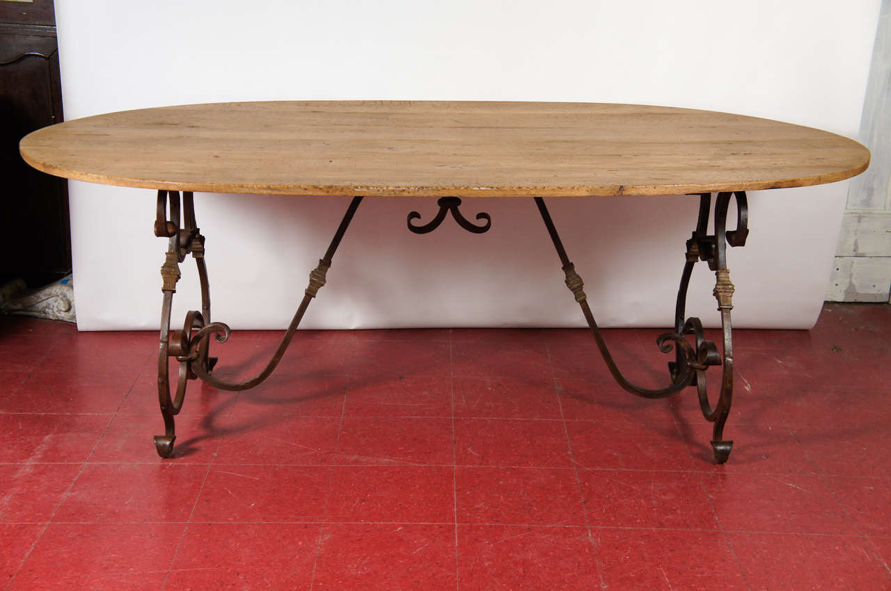 Natural wood metal base dining table (waxed) with elegant French wrought-iron base.  Top and base can be sold separately. Table base measures 23.5 x 55 x 29 h. Top = $2400; Base = $2400.