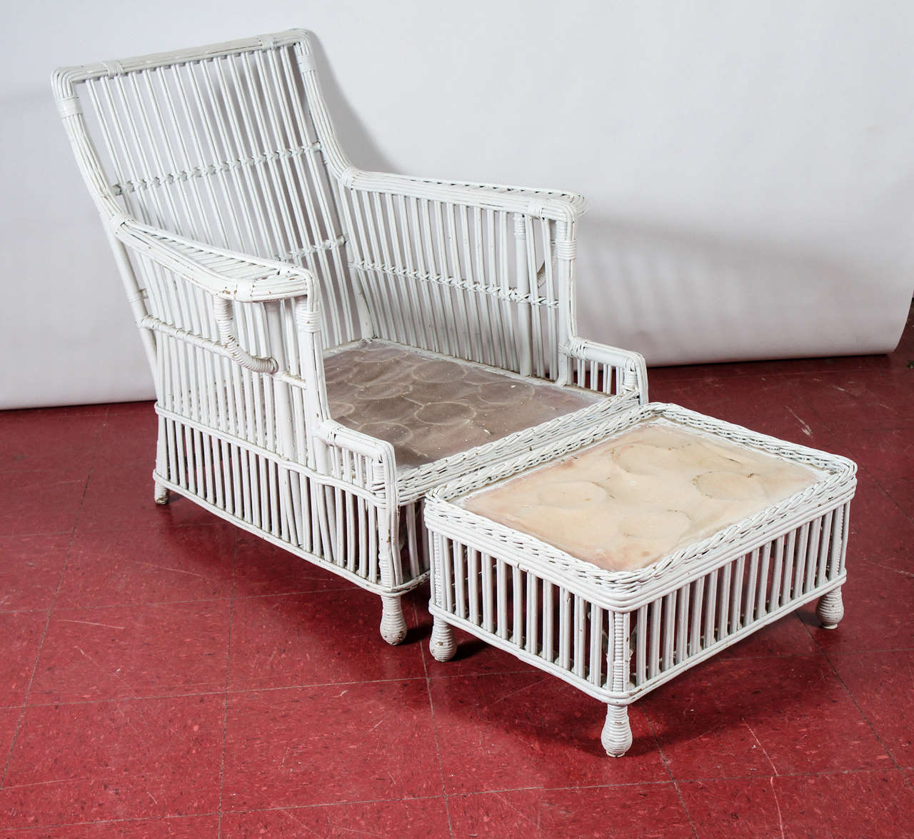 Commodious and solidly constructed bound and woven wicker chair and matching stool or ottoman.  Steel springs under canvas on both pieces are ready to support cushions of your choice.  Metal labels read 