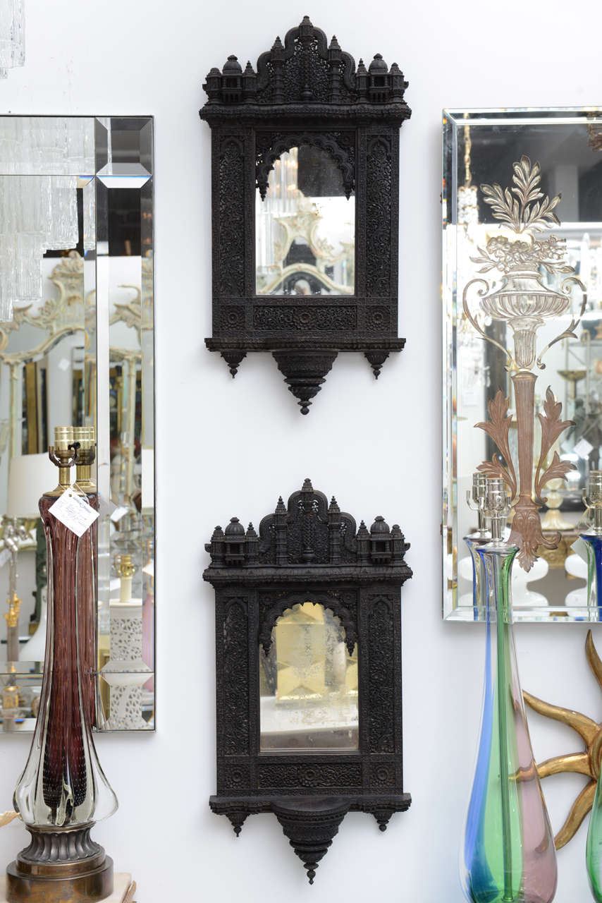 Very intricately carved Anglo Indian mirrors with mercury mirror centers.