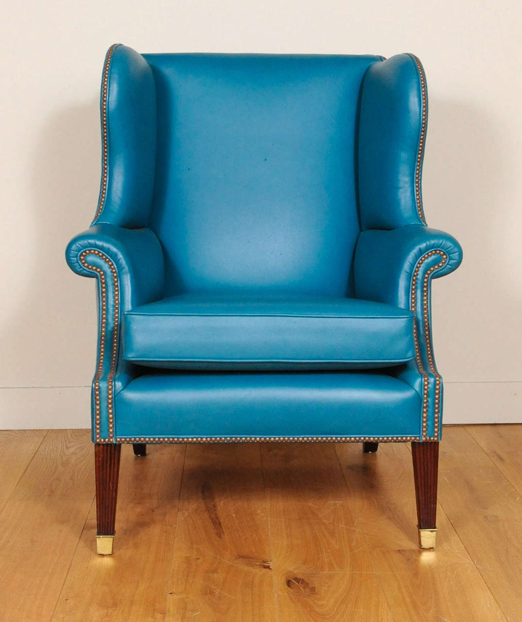A lovely brightblue leather upholstered English wingchair, early 19th century