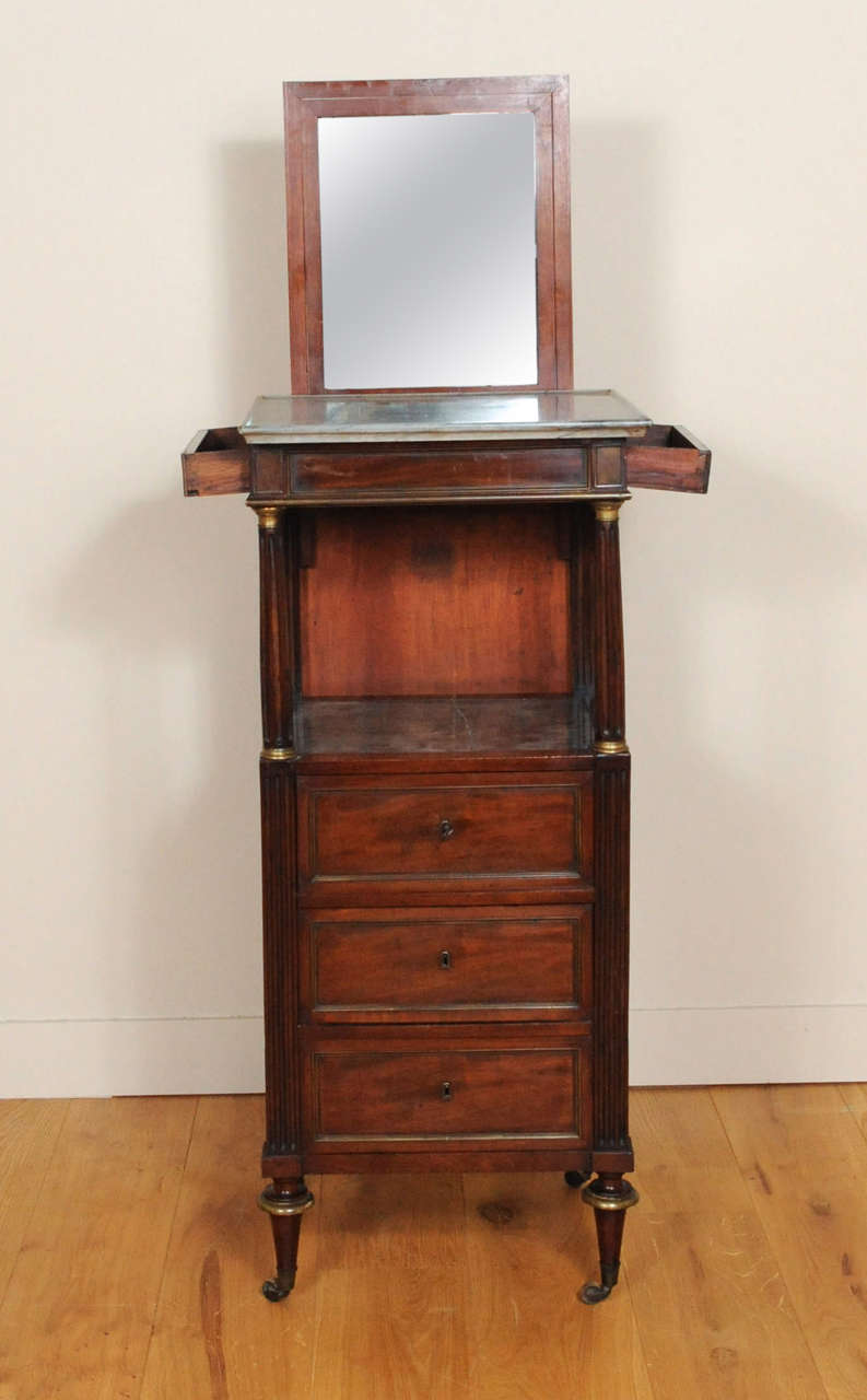 This unique piece has a hidden mirror on the back, which was used to visualise the face while shaving. On both sides just under the top are drawers were the shaving equipment could be placed. This piece of furniture is from about 1800. The cover is