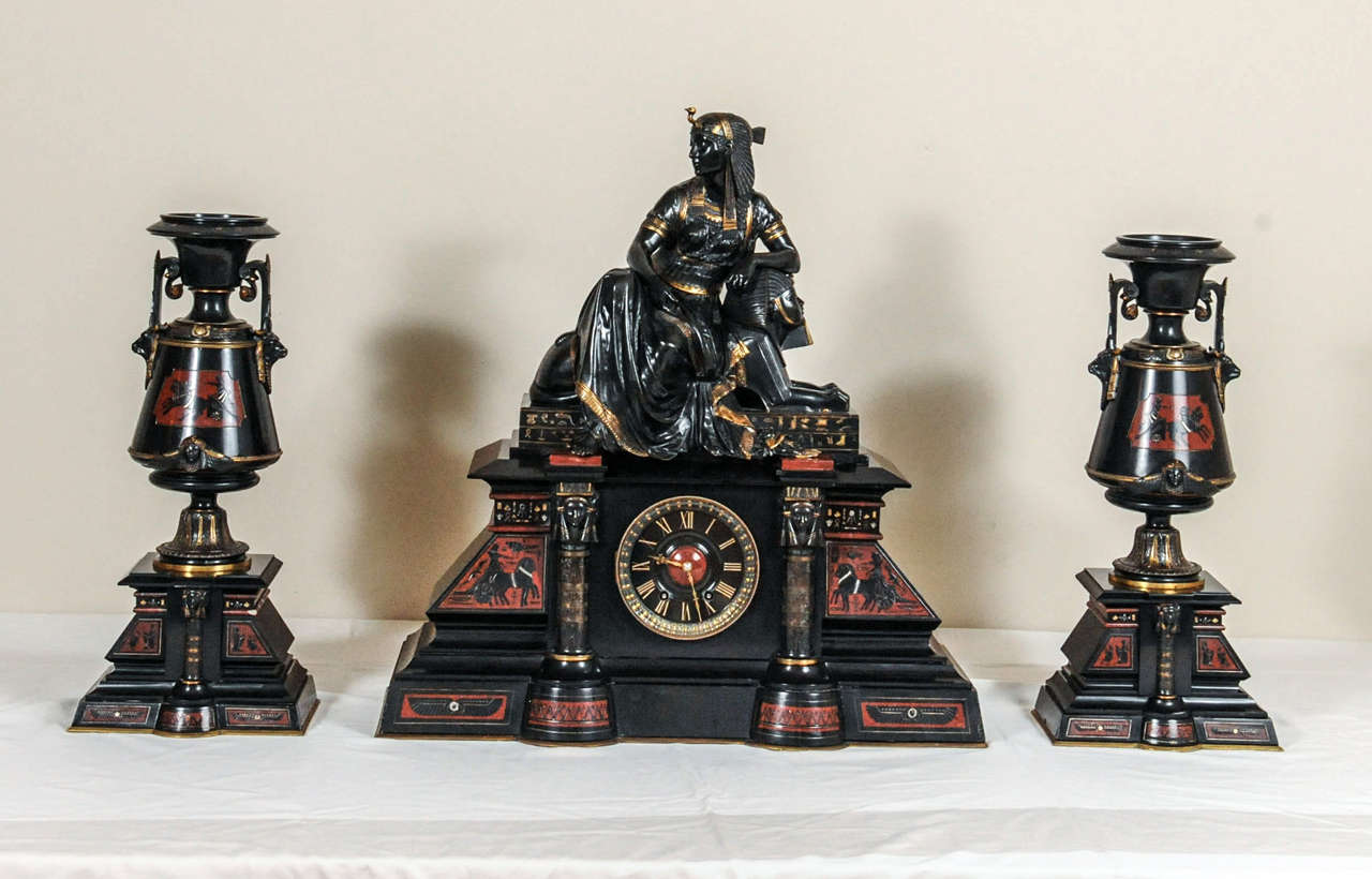 A fantastic black marble ‘retour de l’Egypt’ mantle clock with two side pieces.
