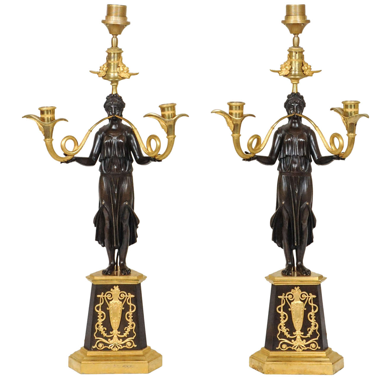 A large pair of ormolu and bronze Nikè Empire candelabra. For Sale