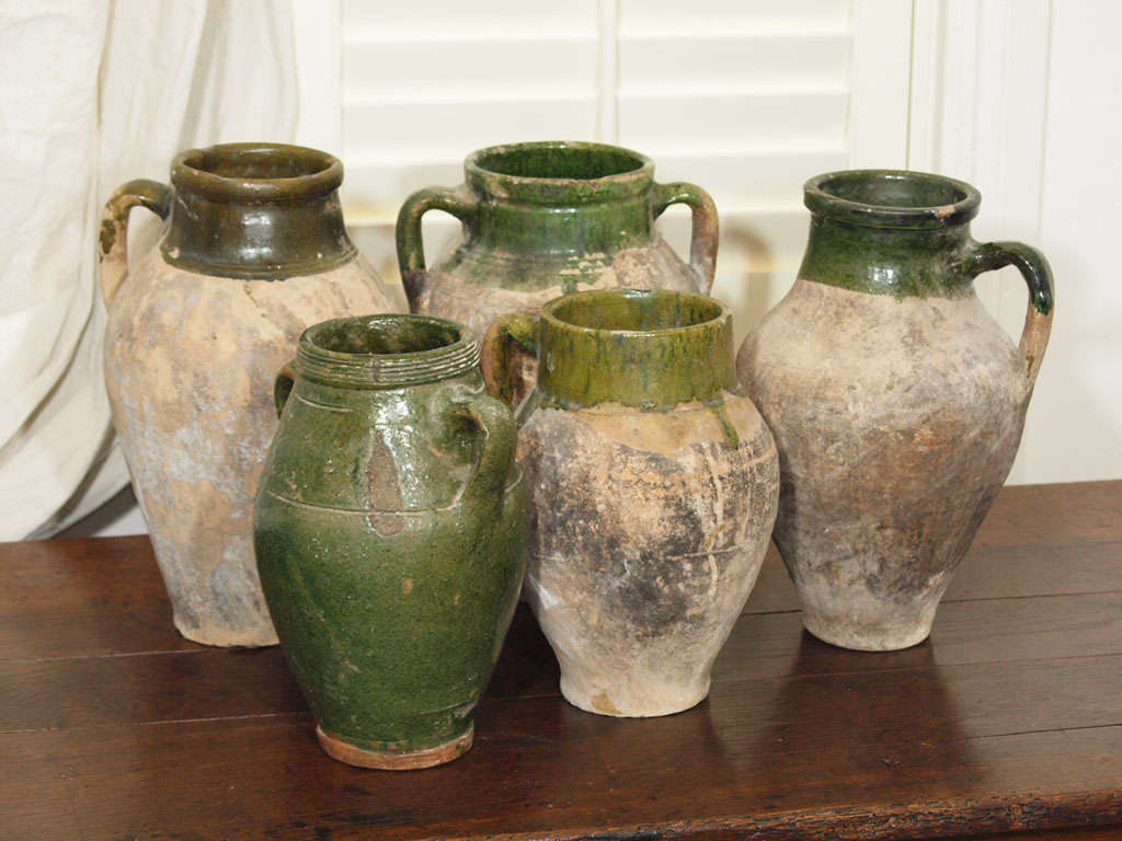 Beautiful rustic antique olive jars with original green glazing.  From the smallest pitcher to the largest oil jar, each is unique in shape, color, and texture. Jars range in sizes with the tallest being 14.25