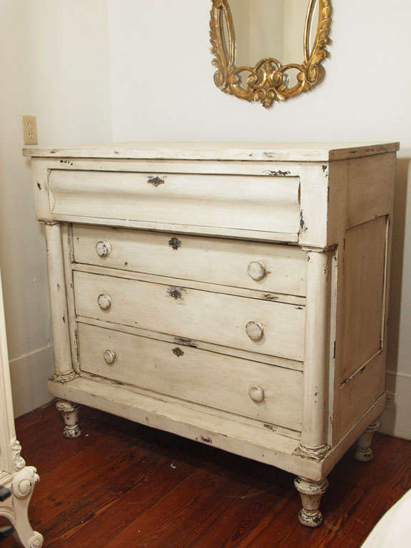 Late 19th c. four drawer painted commode or chest of drawers flanked by columns on each side.  The drawers and columns recessed beneath the plateau, all resting on tapered feet. Painted in an oyster white.  Beautiful patina.