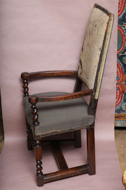 17th C Flemish walnut armchair with square back over caqueteuse arm supports with turned roundels at the end posts over barley twist arm supports over turned legs joined by rare double row of barley twist high stretchers, having very architectural