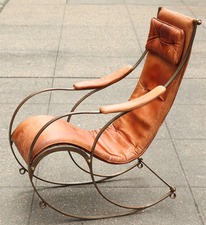 19th Century steel leather and brass rocking chair, by R.W. Winfield of Birmingham, of dynamic form, in padded leather upholstery over wood slatted frame, the whole a study of curvilinear design.

R.W.Winfield first exhibited this chair design at