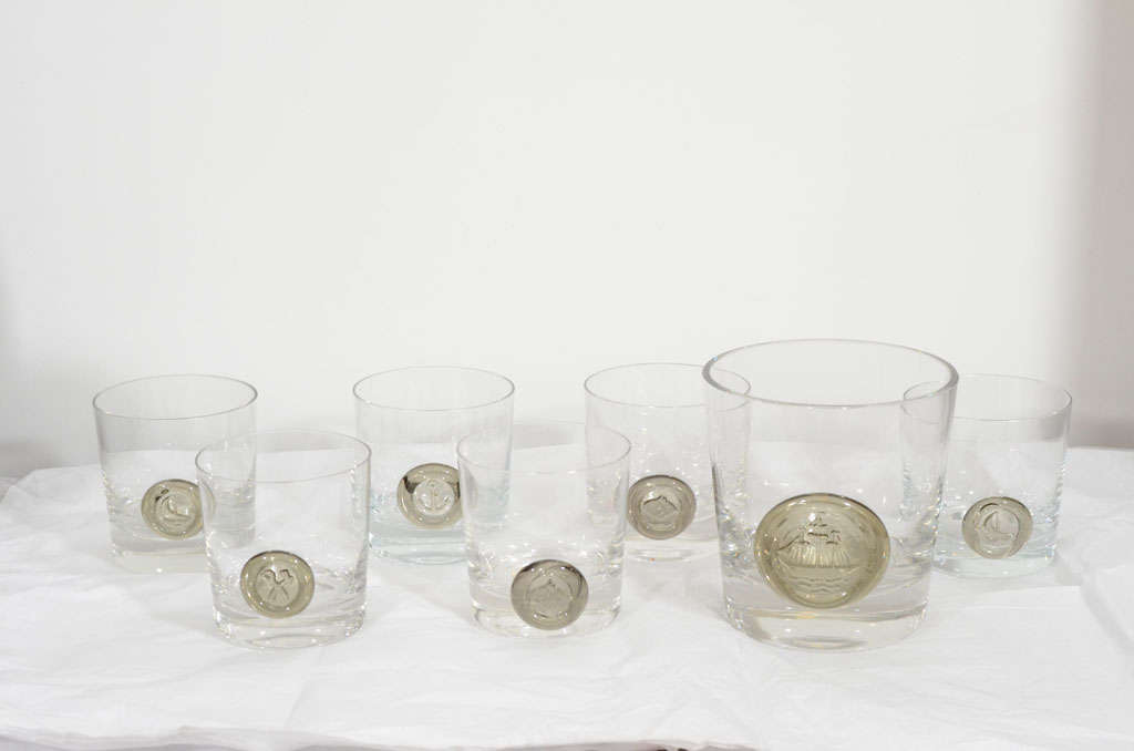Six tumblers and an ice bucket in clear crystal with smoke-grey appliques of nautical themes. Etched logo on bottom of each piece. Glasses 3