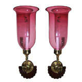 Pair of antique cranberry colored glass shades on sconces