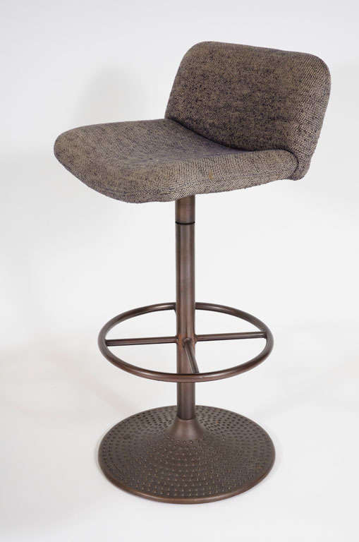 A pair of armless upholstered bar stools with circular footrests and textured bronze finished metal bases.  With distributor's label ICF.  Finnish, circa 1970.<br />
Price is COM.