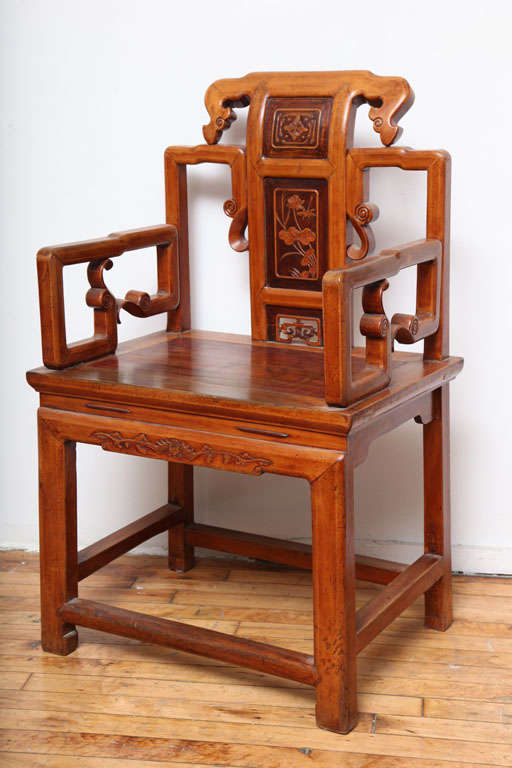 A well crafted armchair , circa 1900, from Ningbo, China. The chair has a backsplat with relief carving in contrasting colors. Well made joints and a soft patina. Very gently restored.