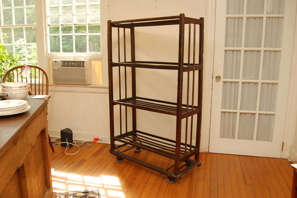 This original shoe drying rack came from a factory in the Pennsylvania area. It has wonderful old metal casters which allow it to roll about easily. This rack is taller than most which is great since it takes up less room. it is perfect for almost
