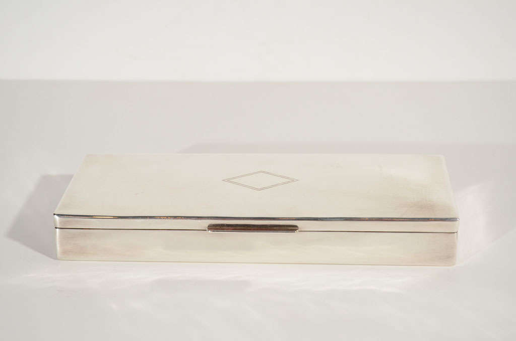 Art Deco style silver box with <br />
egraved diamond design on top<br />
and fitted with a wood interior. <br />
Signed Ralph Lauren on the under-<br />
side. A wonderful addition to the <br />
well appointed dresser, vanity, <br />
or desk.