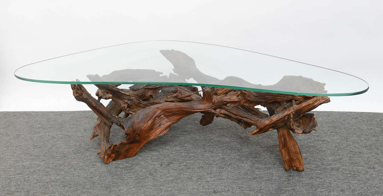 For the lover of organic piece, this vintage wine tree coffee table will add a grounding natural element to your décor. Dark, twisted branches reminiscent of the California wineyard. The tree is topped with a kidney shape glass top.
Kidney shape