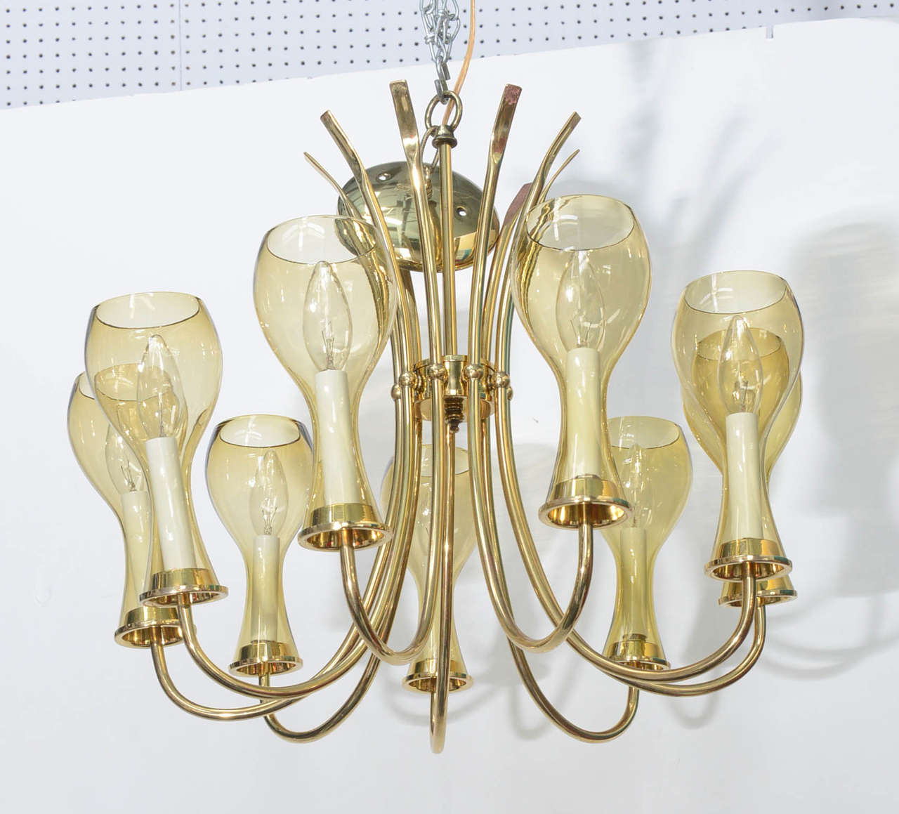 Light up your retro room in style with this glamorous chandelier from the seventies.  Eight candelabra lights provide ample sparkle and shine for your dining or entrance area. The chandelier has been rewired and the brass polished and a clear has