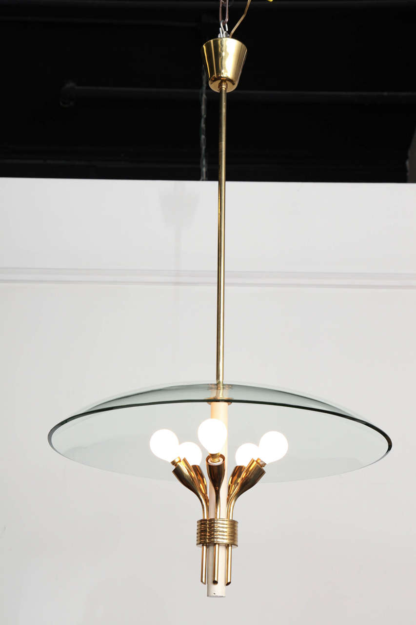 Elegant Arredoluce style chandelier made in Milan, 1950, blown curved glass shade over five hand tooled brass sockets on a white stem, unusual form great quality.
  