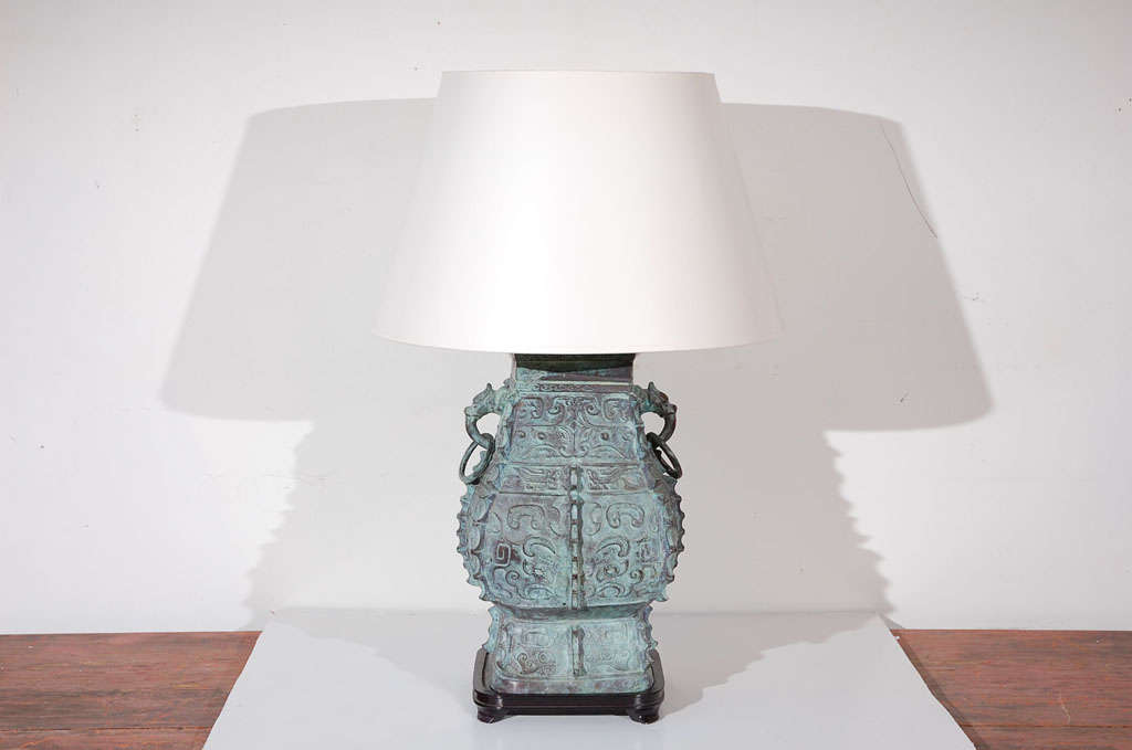 BEAUTIFULLY SHAPED ,CLASSIC CHINESE STYLE PATINATED  LAMP WITH WOOD BASE AND CAP.  THE MEASUREMENT IS UP TO THE HARP.